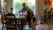 Maureen McKinley helps her children through some study exercises in her family's dining room in Phoenix. McKinley and her husband, Matt, home-school their five children and offer the older children a curriculum that includes Latin.